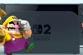 Switch-2-console-docked-with-an-image-of-Wario-holding-a-stack-of-coins-to-the-left-1_hd.jpg