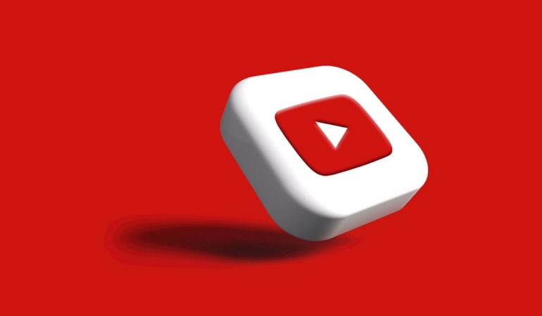 a-white-cube-with-a-red-arrow-on-a-red-background-youtube-settings-auto-dubbing-video-language.jpg